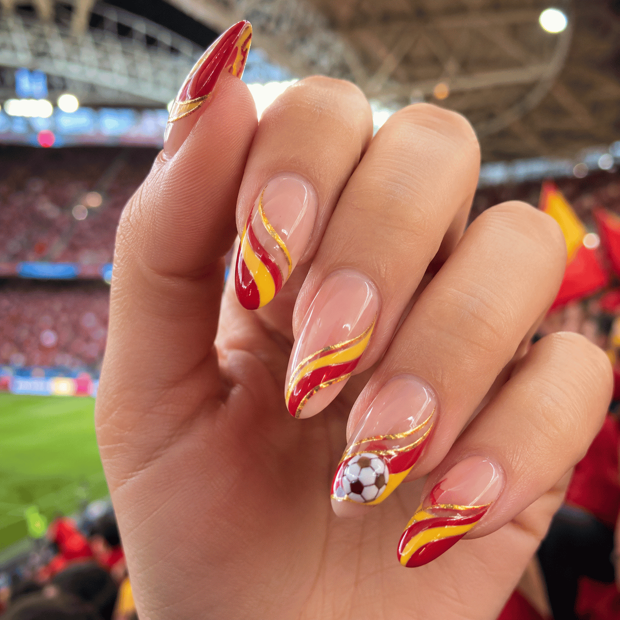 Spain football fan nails featuring flowing red and yellow wave nail art inspired by Spanish stadium celebrations.