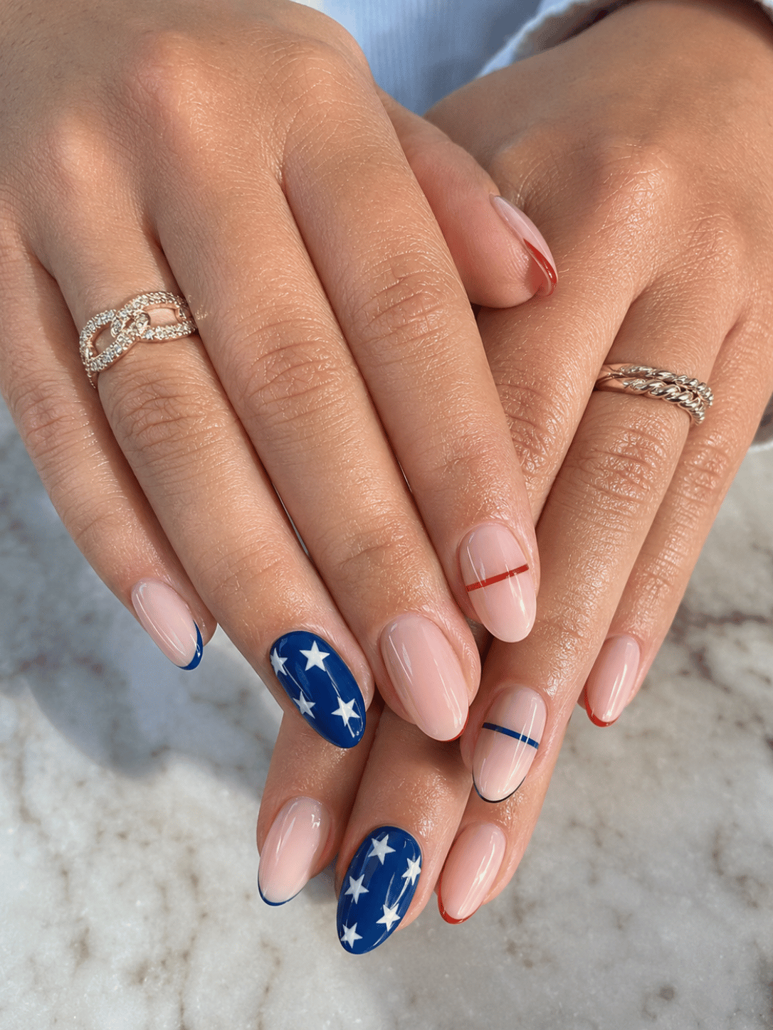 Stars and stripes match day nails with red stripe accents and white stars on cobalt blue almond nails for USA soccer fans