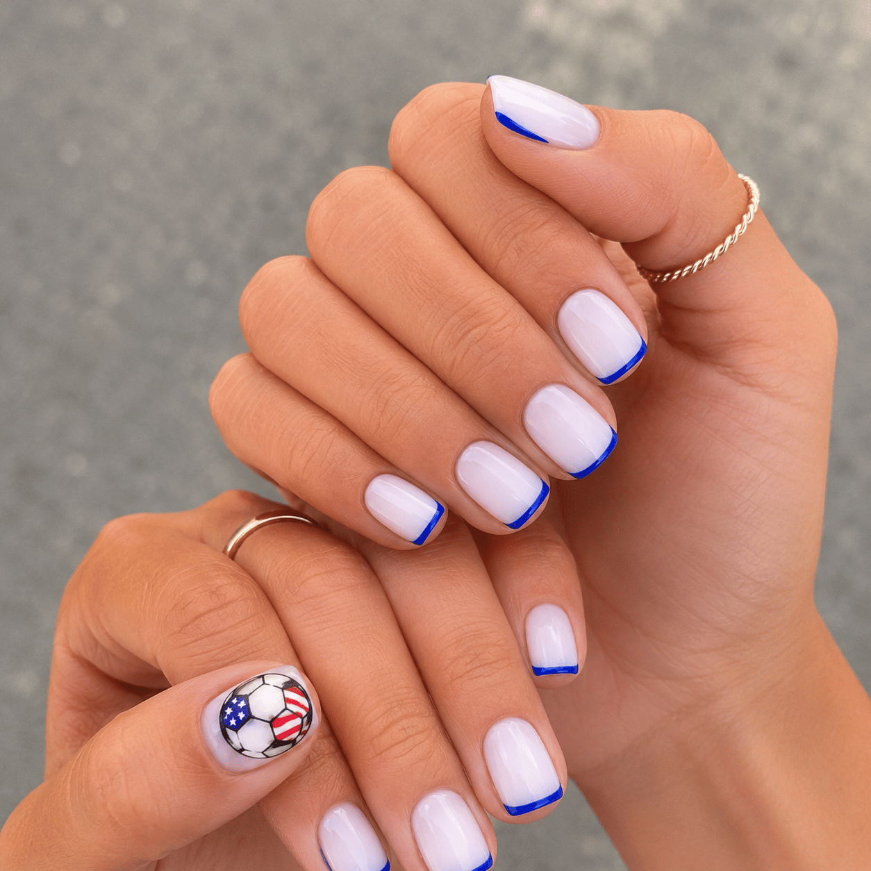 USA soccer ball accent nails with white base, blue French tips and simplified American flag soccer ball design