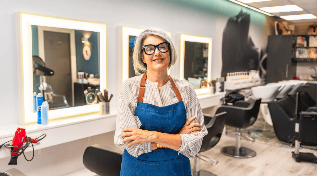 Cosmetologist standing confidently in a modern salon