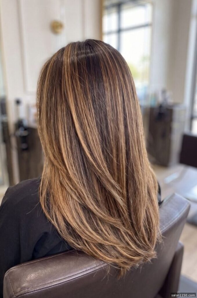 Dimensional bronde hair color with blonde and brunette tones shown in salon light