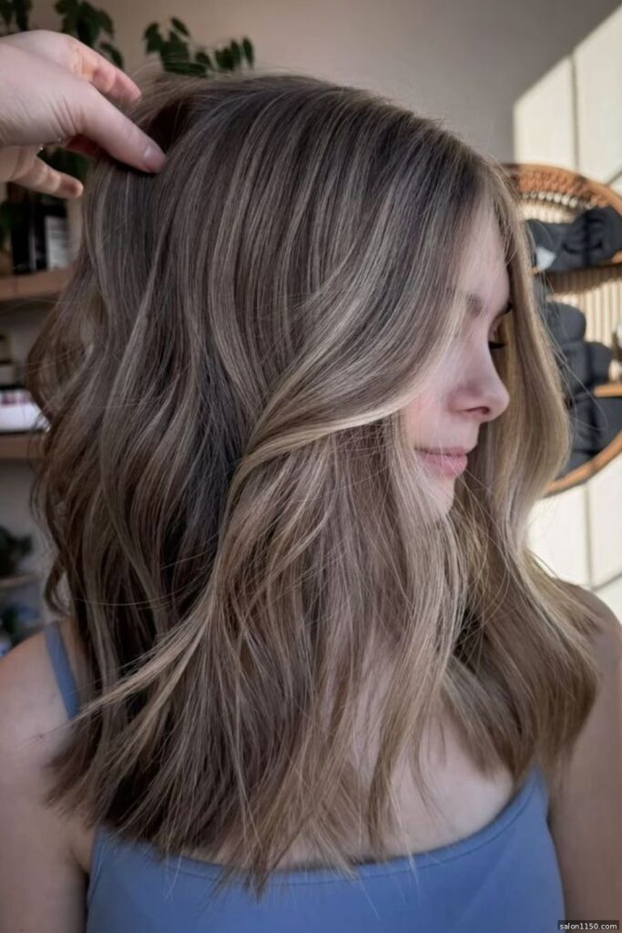 Bronde hair color on a lob haircut showing dimensional ash tones