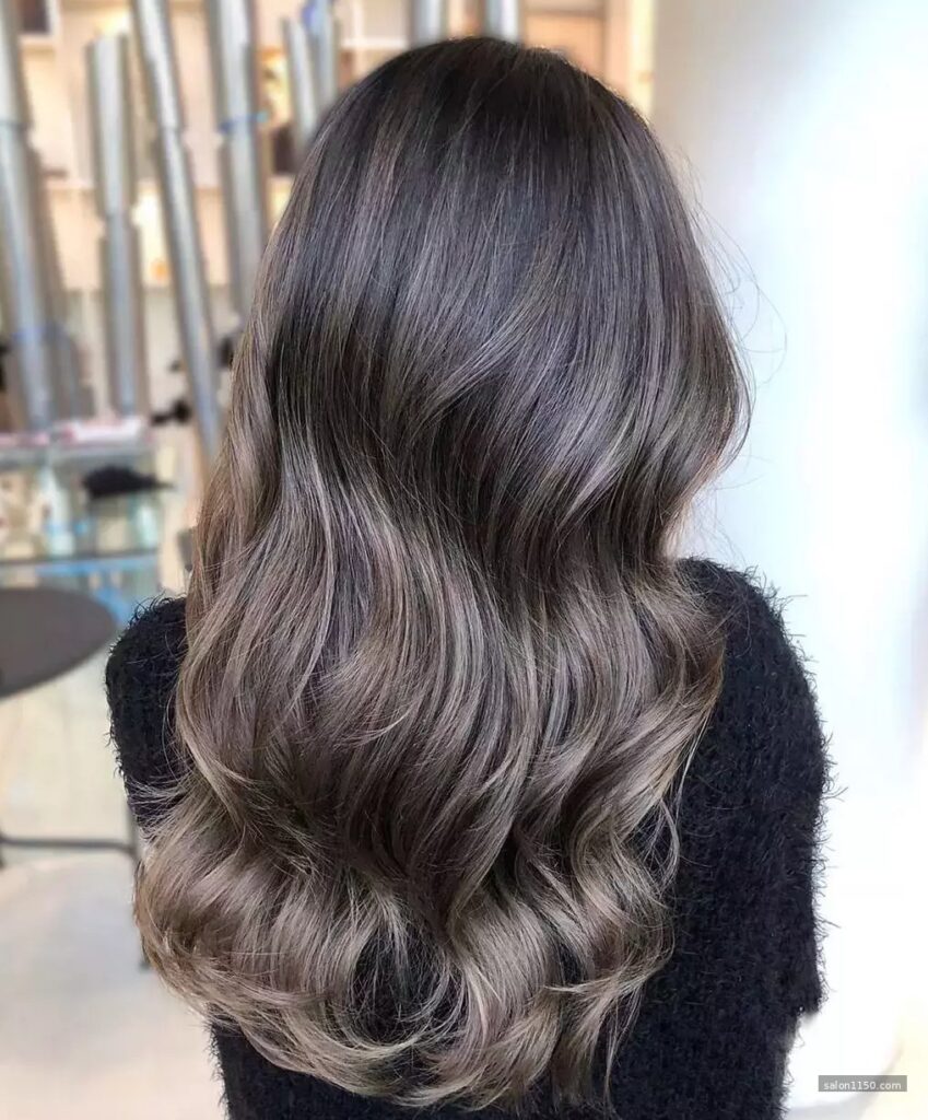 Cool ashy chocolate brown hair color with smoky tones in overcast outdoor light