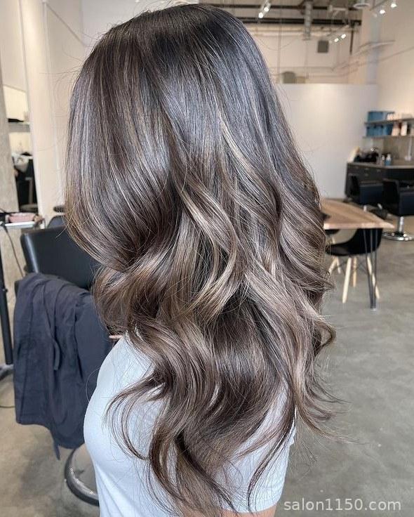 Classic mushroom brown hair color with cool gray-brown dimension shown in salon lighting