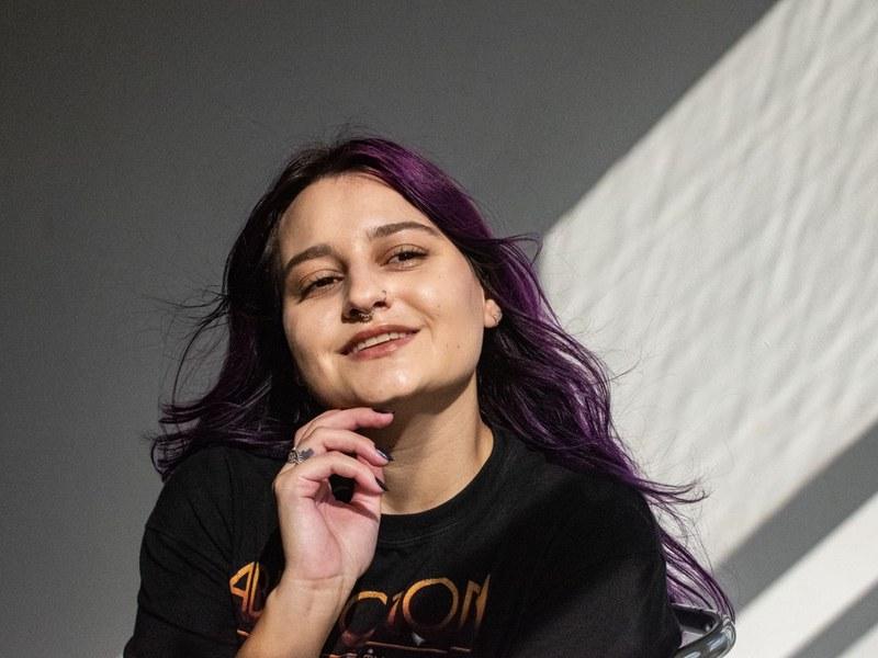 Smiling woman with vivid plum purple hair